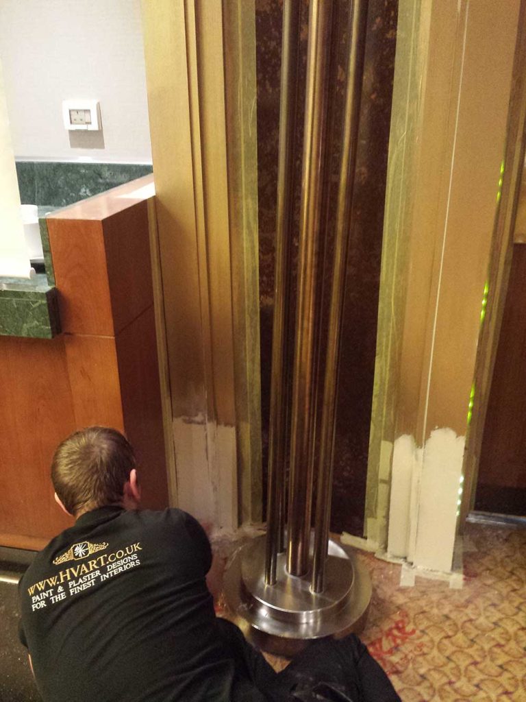 Restoration works on faux bronze finishes on board the QM2 cruising to New York.